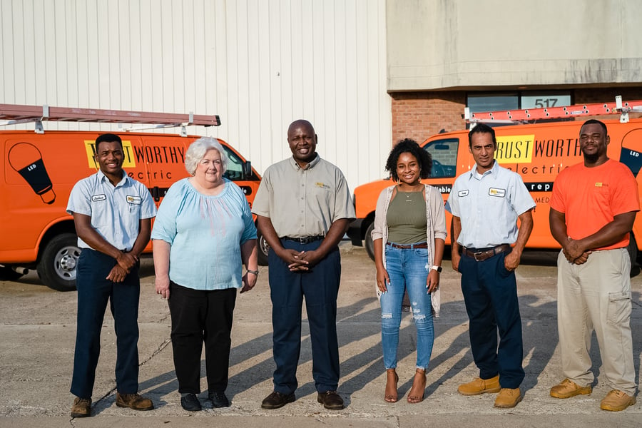 Trustworthy Electric team standing in front of company vans
